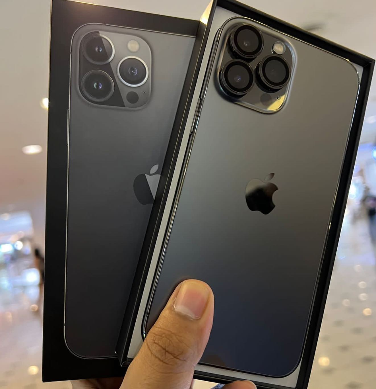 Graphite iPhone shown with its box in a historical A&Z social photograph
